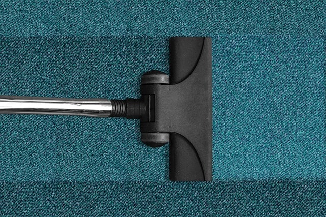 a vaccum cleaning carpet in an aprtment in arizona